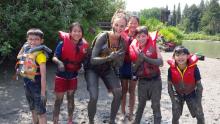 kids smiling after playing in mud